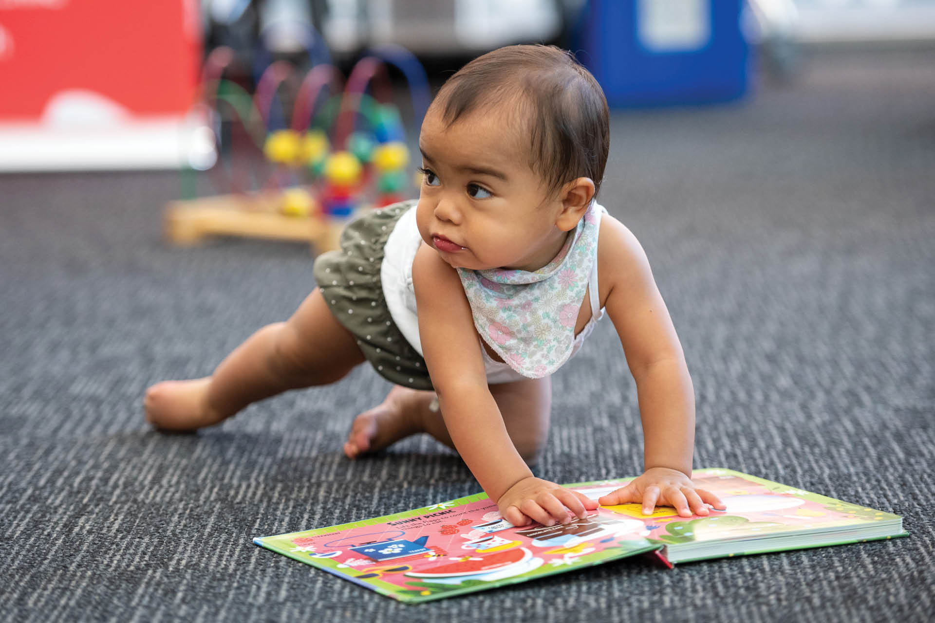 Baby crawling over open book