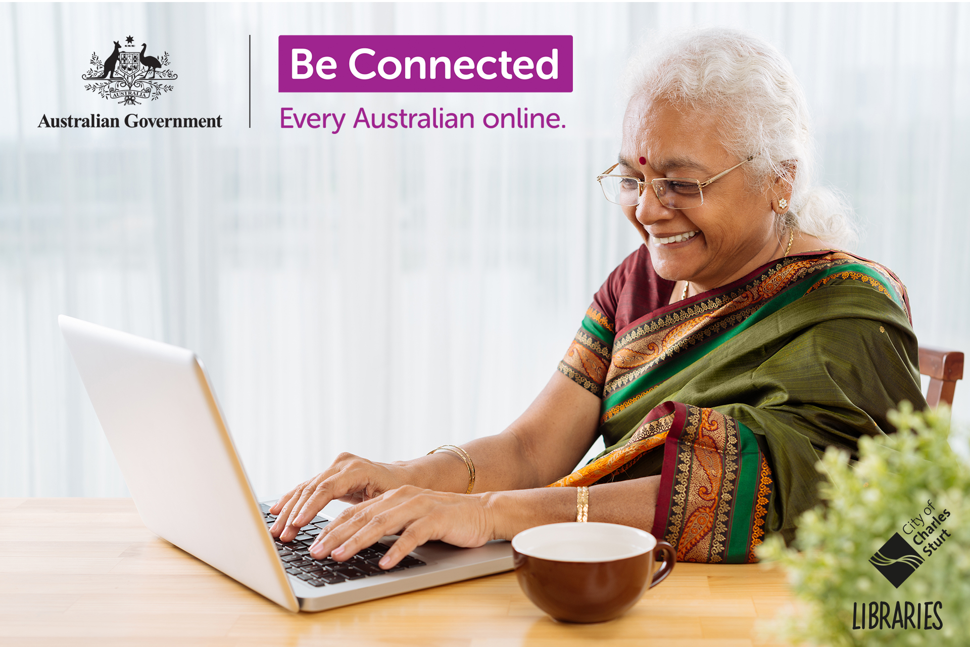 Senior indian lady smiling and looking at laptop